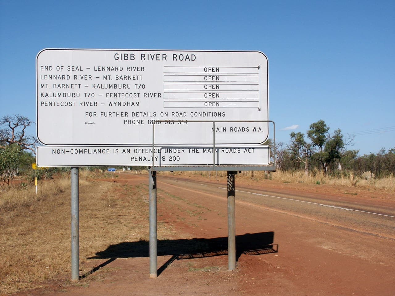 Gibb River Road running toward distant Kimberley ranges on a dry-season afternoon